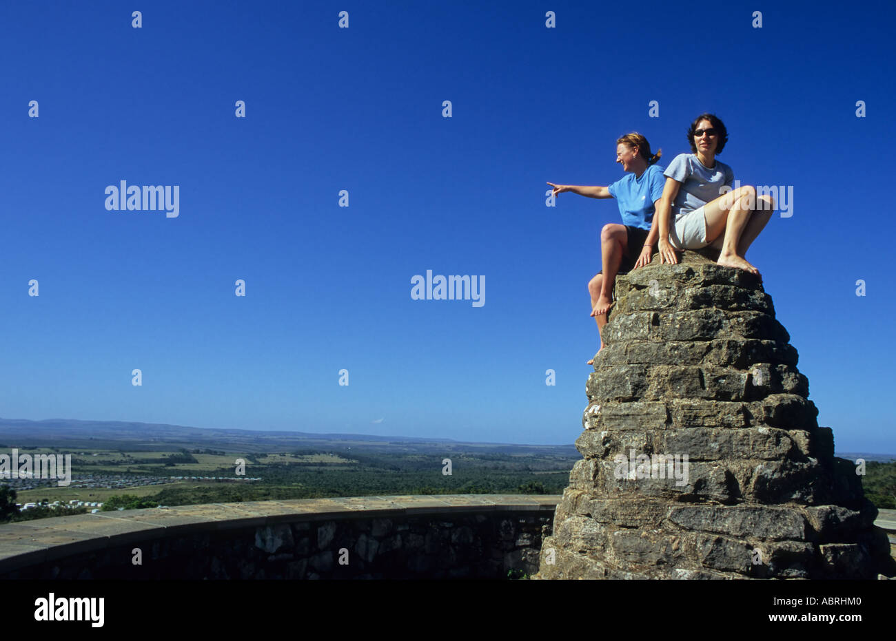 Two girls sitting on toposcope feature, Bathurst, South Africa Stock