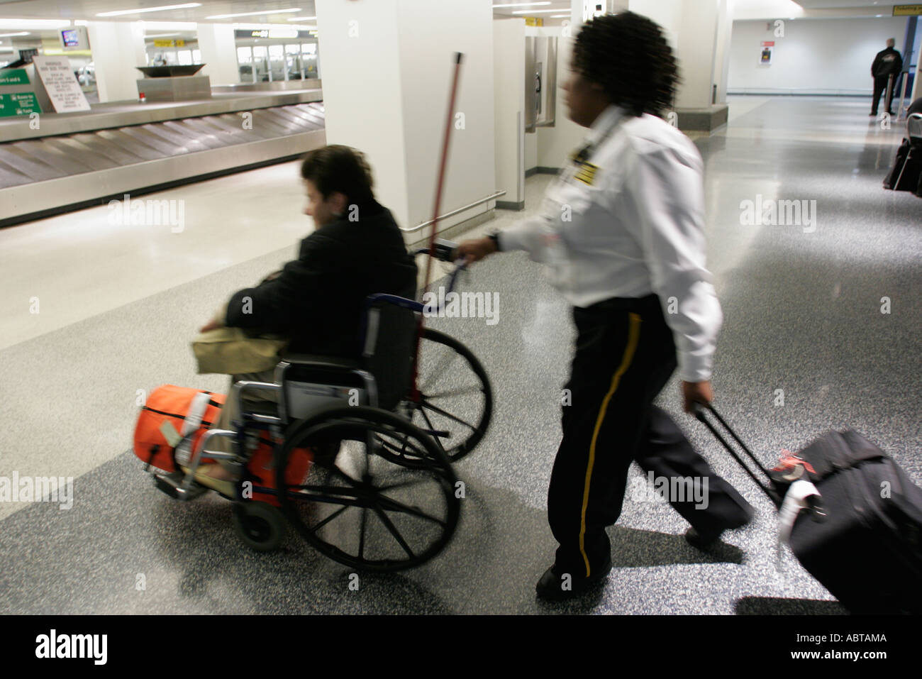 New Jersey Newark Airport Black female attendant pushes wheelchair