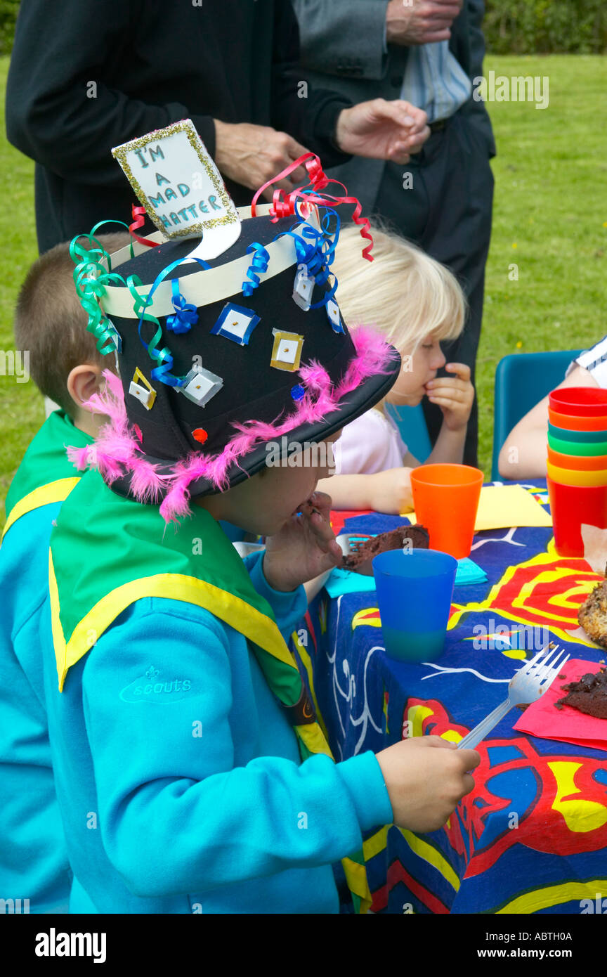 Scouts and cubs enjoying a mad hatters tea party at a countryside event Stock Photo