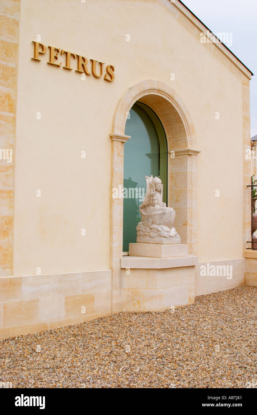 The newly renovated Chateau Petrus with a sign with the name in gold and a  stone statue of Peter the Apostle in a boat with fishing net in a niche  Pomerol Bordeaux