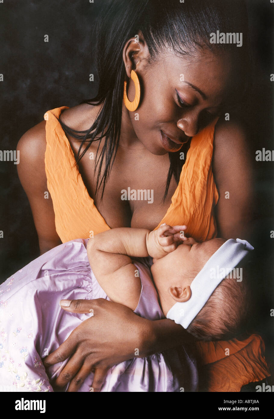 Coloured Mother Holding Her Baby Stock Photo