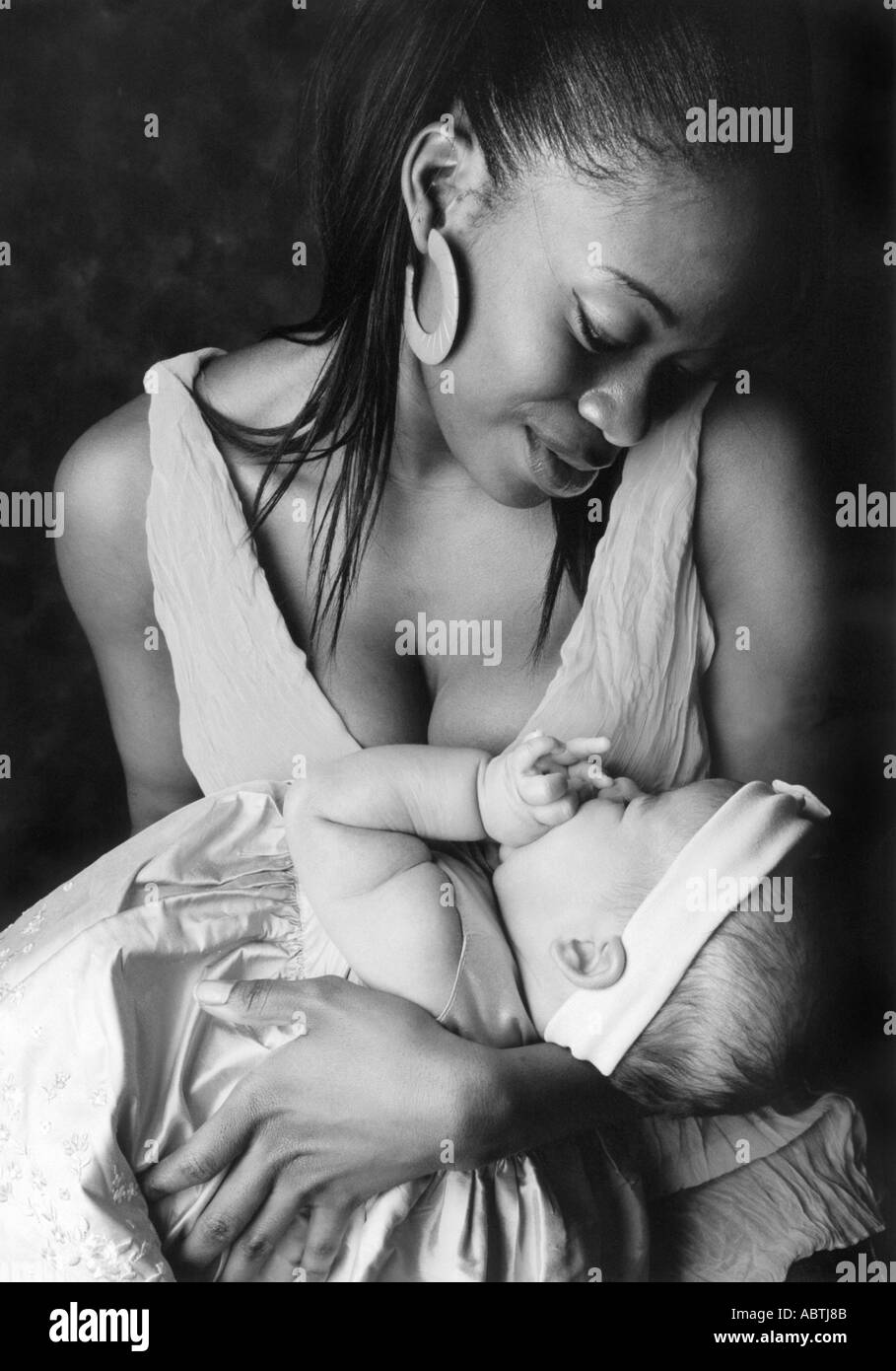 Coloured Mother Holding Her Baby Stock Photo
