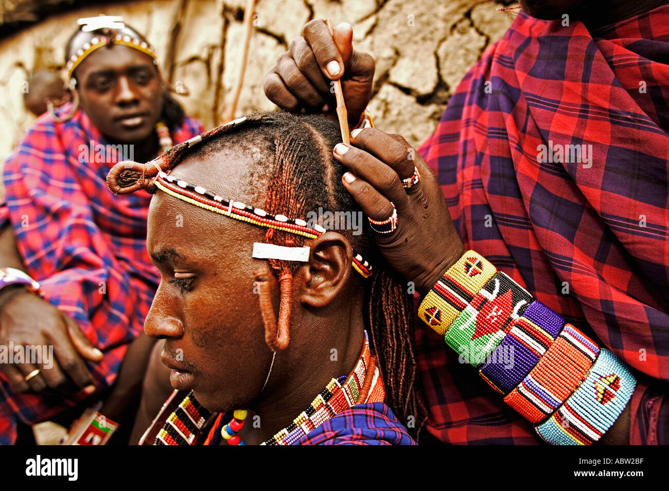 Maasai Men spend hours braiding each others long ochred colored hair Model released Kenya Stock Photo