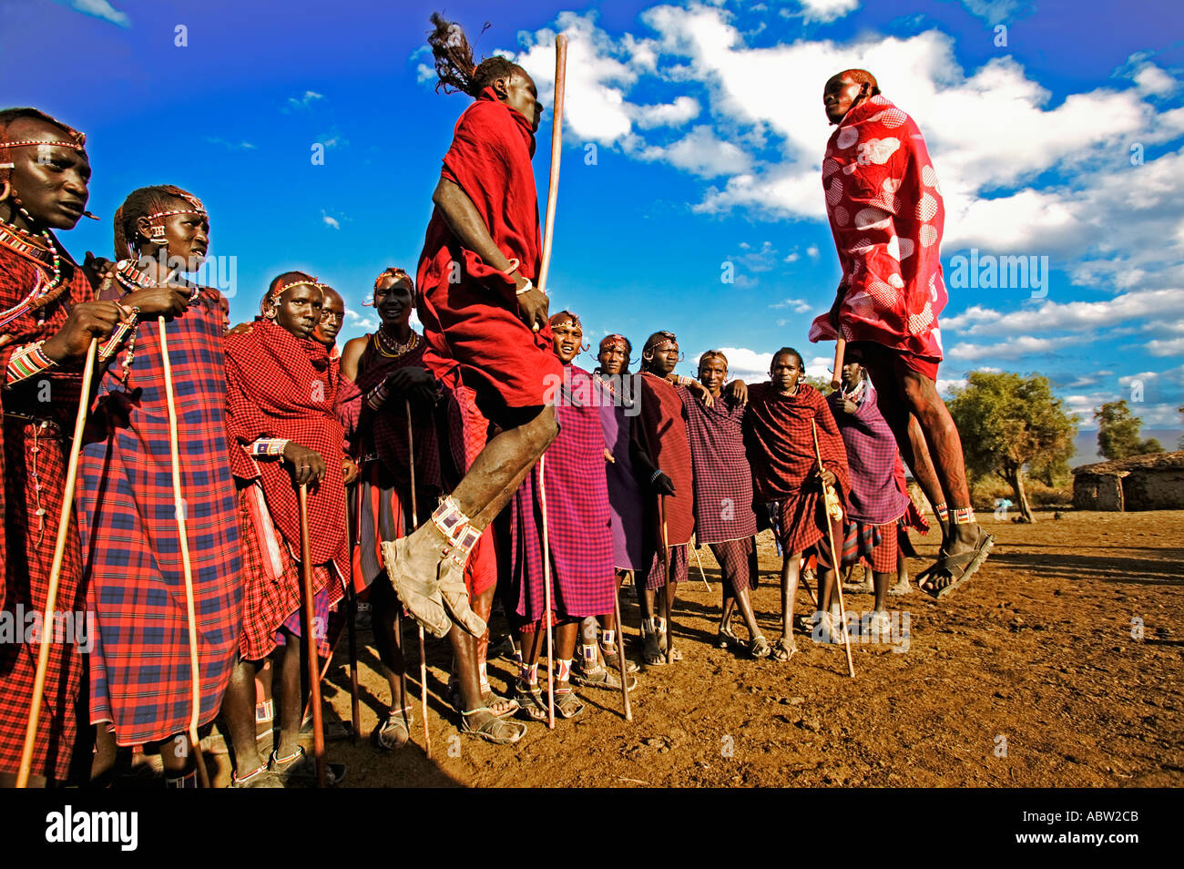 Maasai Warrior jumping dance Leap into the air to demonstrate strength and agility Kenya Stock Photo