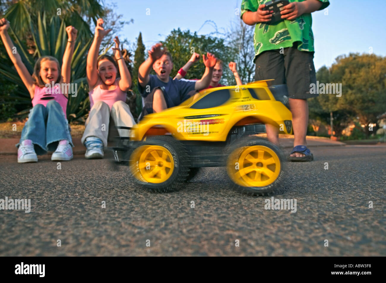 Children playing with radio controlled car Model Released Stock Photo