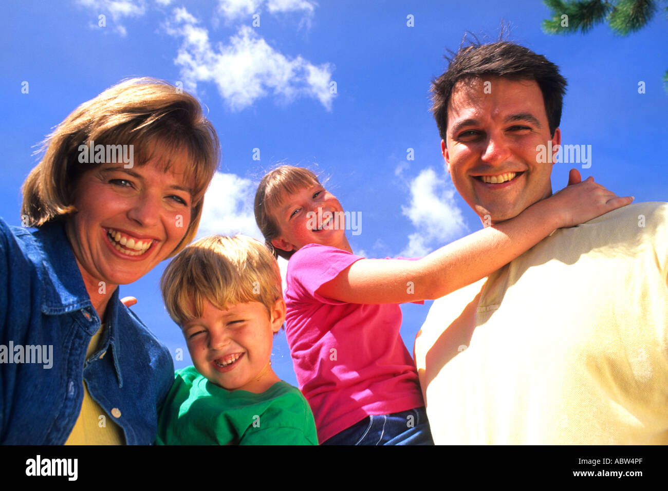 Young affluent family spending quality time together at a local park portrait from below Stock Photo