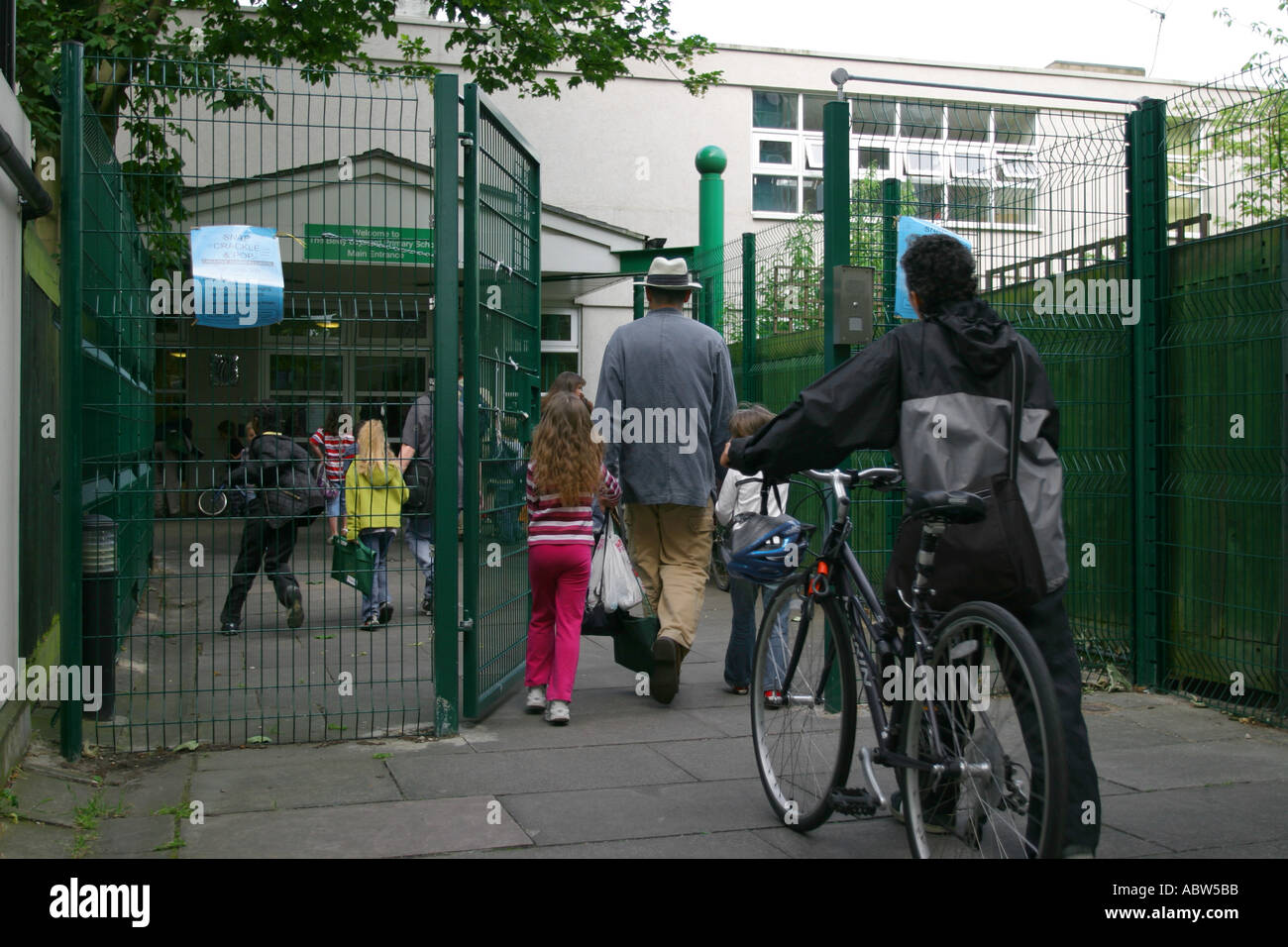 Parents and their children arrive at Betty Layward primary School in the morning, London, UK. Stock Photo