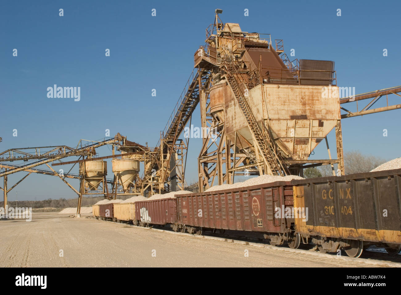 Loaded railroad gondola cars at central Texas crushed stone rock quarry plant awaiting shipment Stock Photo