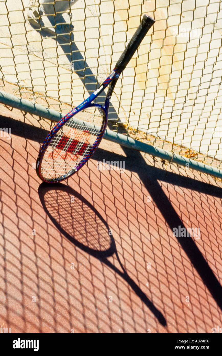 tennis racket leaning on a fence Stock Photo - Alamy
