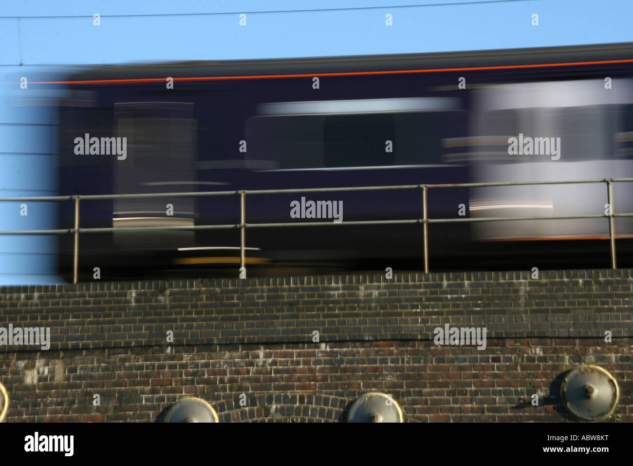 Train Crosses Bridge at Speed Stock Photo Alamy