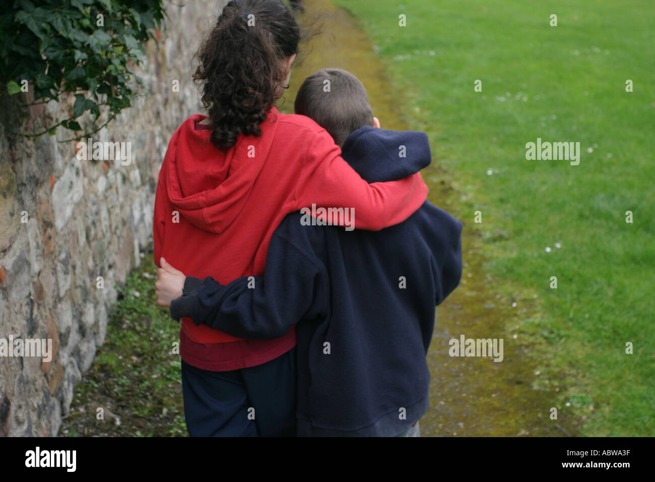 Two siblings walking together, Berwick upon Tweed, Northumbria, UK. Stock Photo