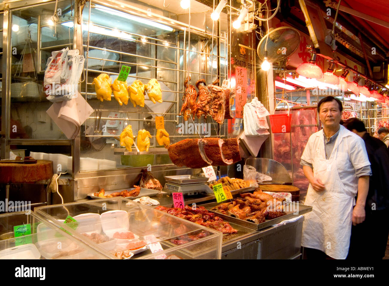 Night market scene with vegetables and food with vendors in Gloucester Road area of busy Hong