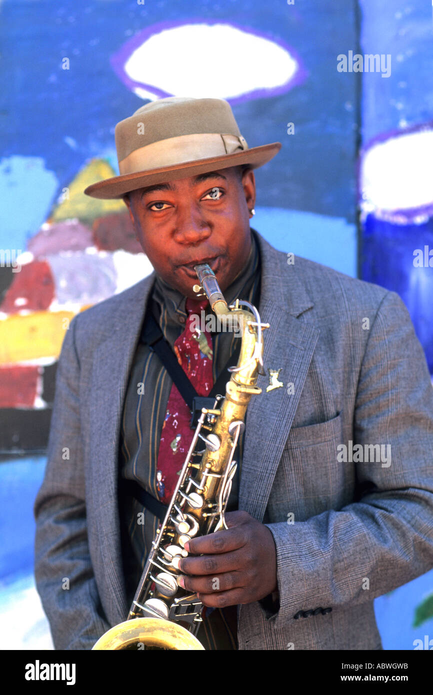 Black Afro American man playing jazz with saxophone or sax near