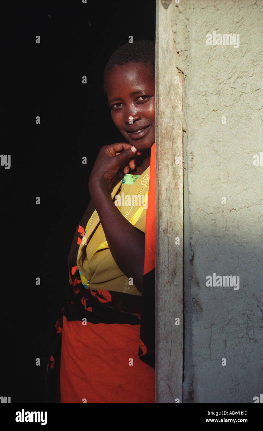 Maasai woman stands in the doorway of her house Shambarai Tanzania East Africa Stock Photo