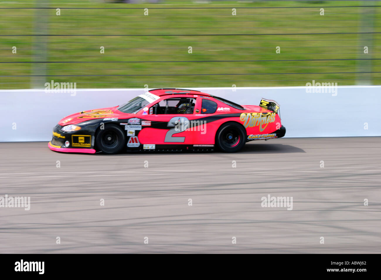 V8 Nascar type stock cars racing on a banked oval circuit Stock Photo ...