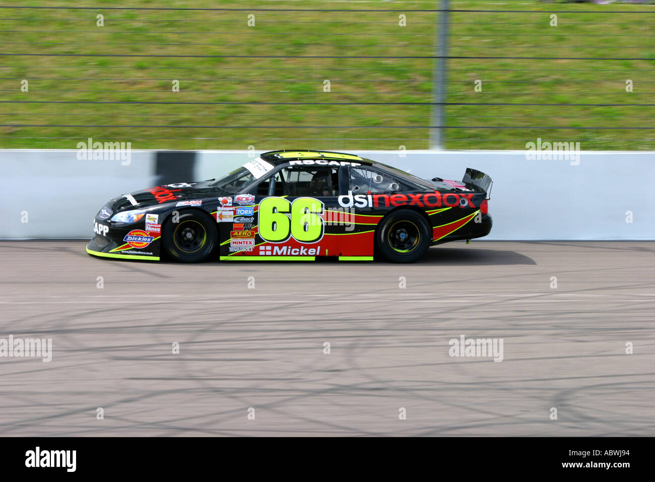 V8 Nascar type stock cars racing on a banked oval circuit Stock Photo ...