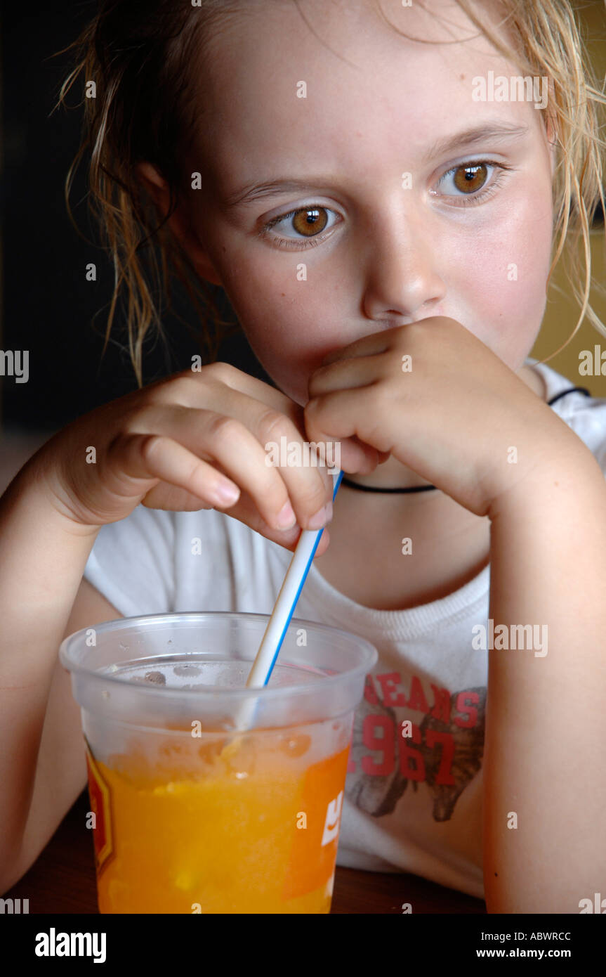 girl drinking a orange juice Stock Photo - Alamy