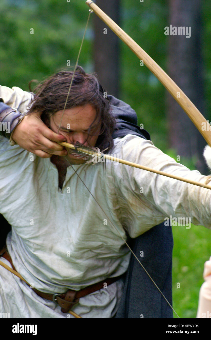 Archer with bow in forest, touch of history Stock Photo Alamy