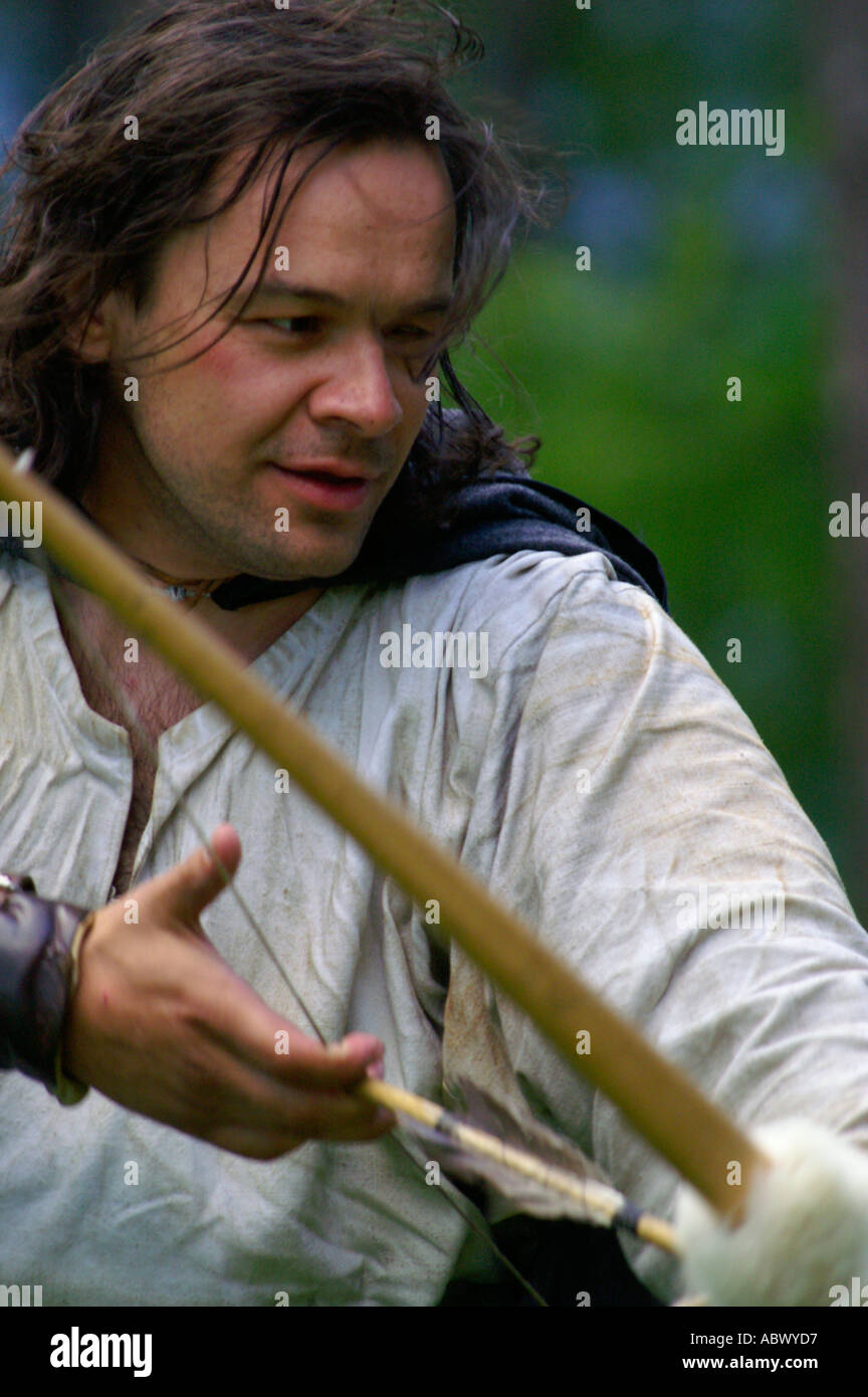 Archer holding historic bow outdoors, touch of history Stock Photo Alamy