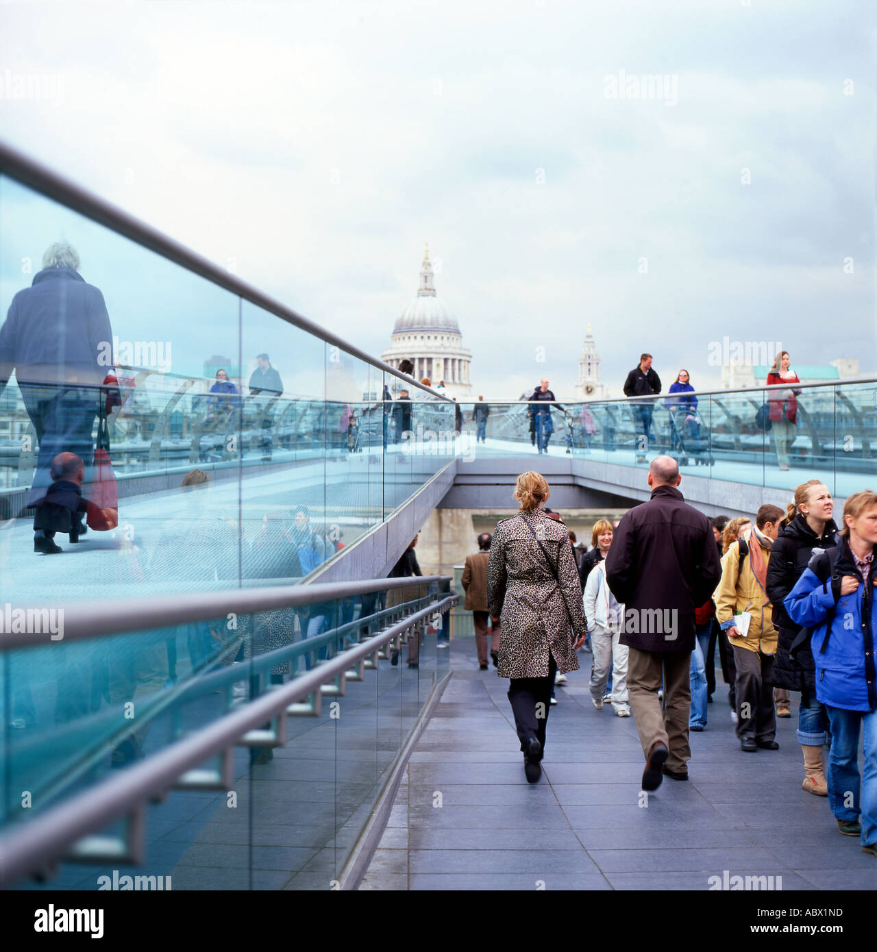 Pedestrians walking across the Millennium Bridge in London UK  KATHY DEWITT Stock Photo