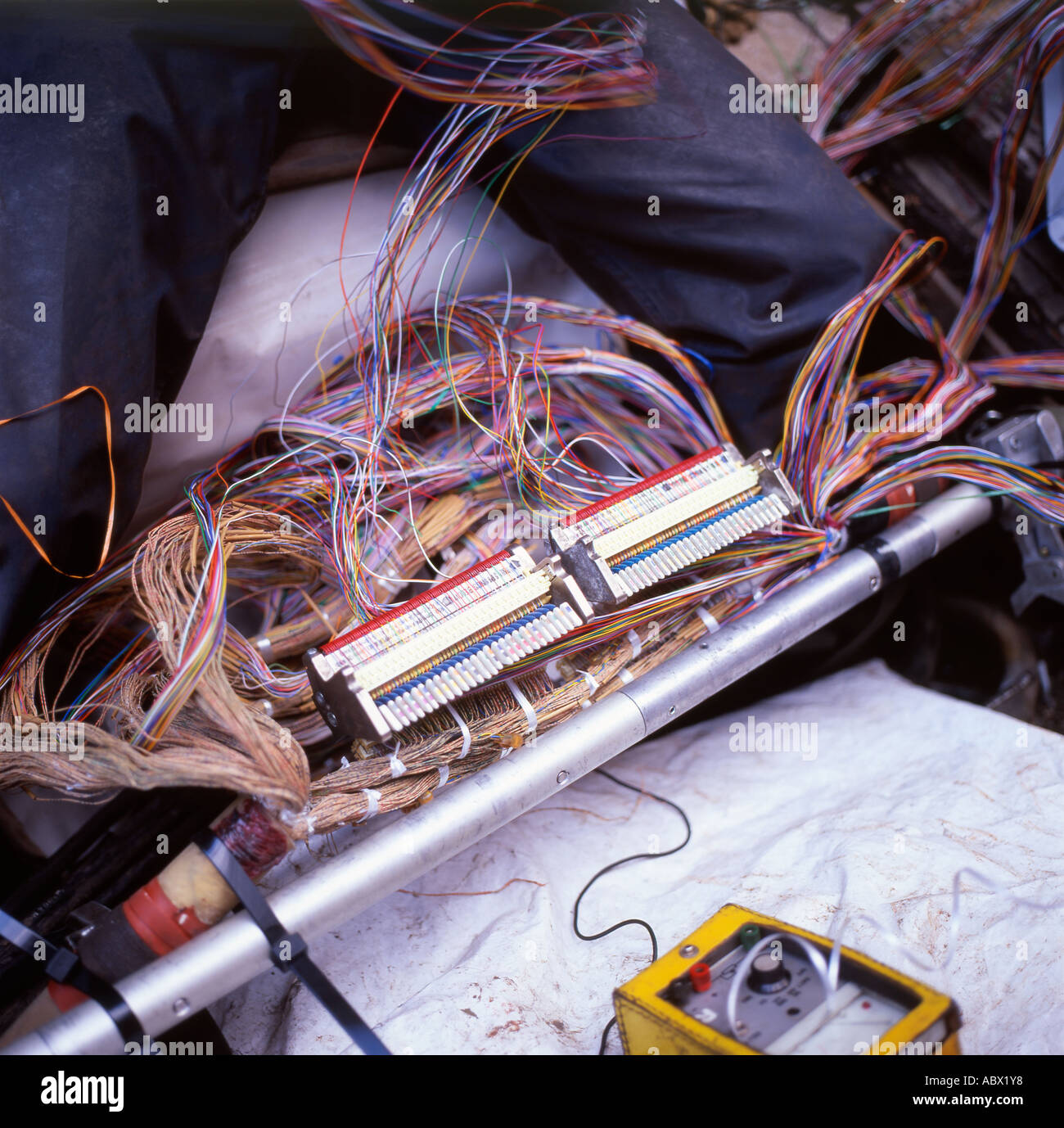A British Telecom worker working with wiring from under pavement Regent Street London UK - Stock