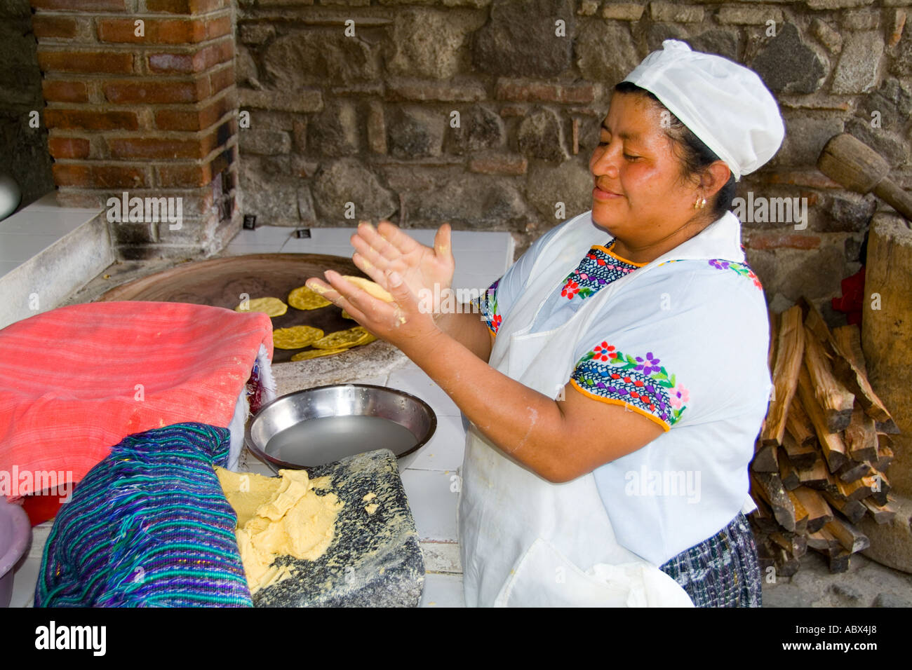 Beautiful local woman making tortillas at over in La Posada de Don