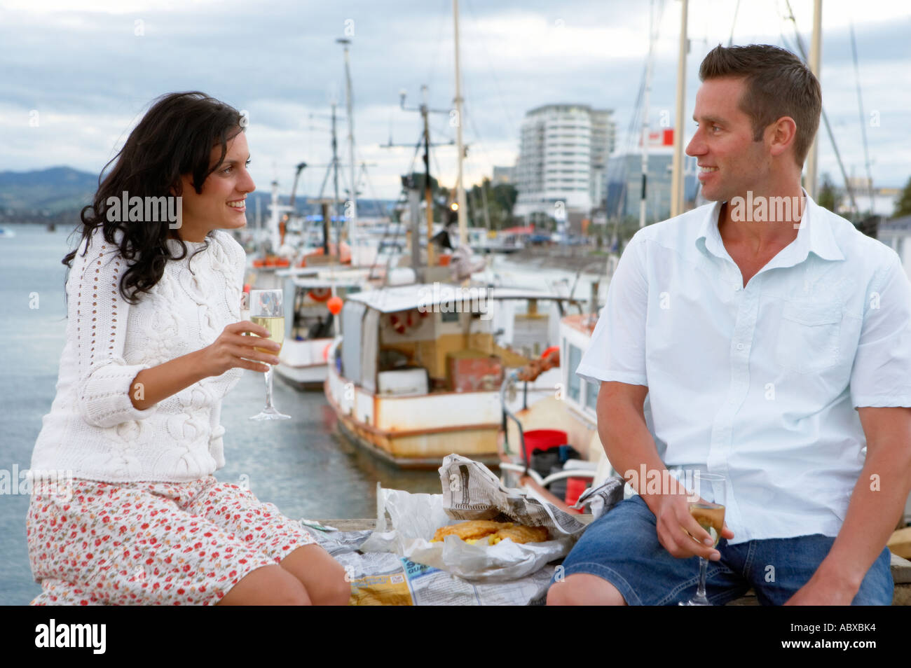 Couple having fish and chips on Tauranga wharf Bay of Plenty New