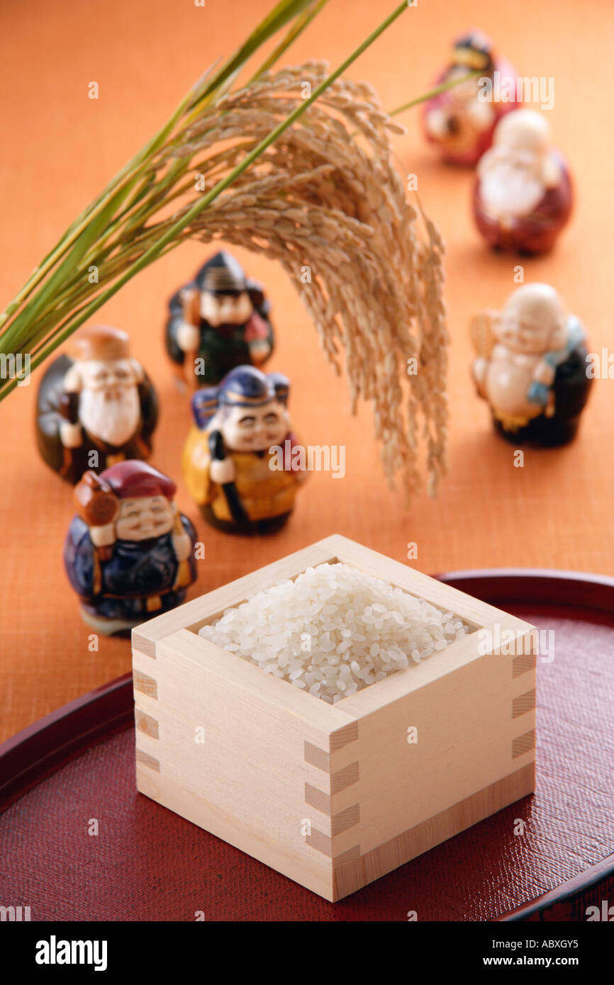 Uncooked rice and figurines Stock Photo