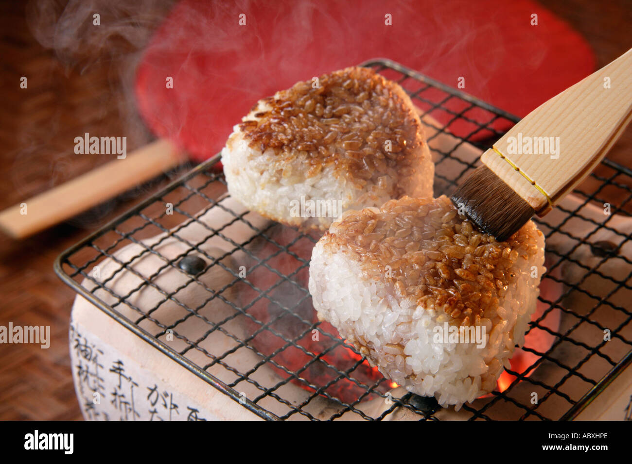 Grilled rice balls over charcoal fire Stock Photo - Alamy