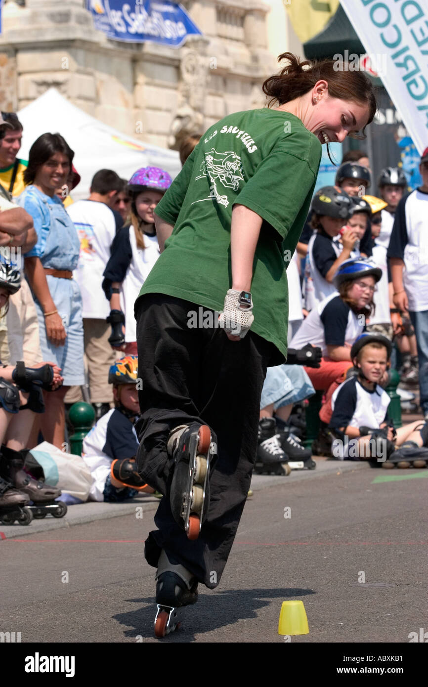 Young woman roller blading through slalom cones Stock Photo Alamy