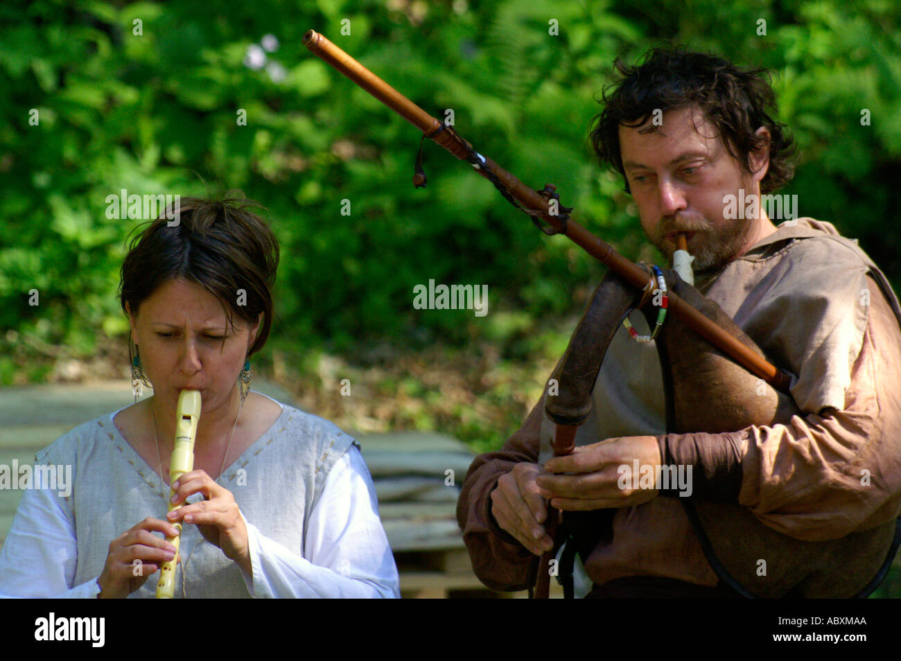 Musicians playing historic flute instrument outdoors Stock Photo