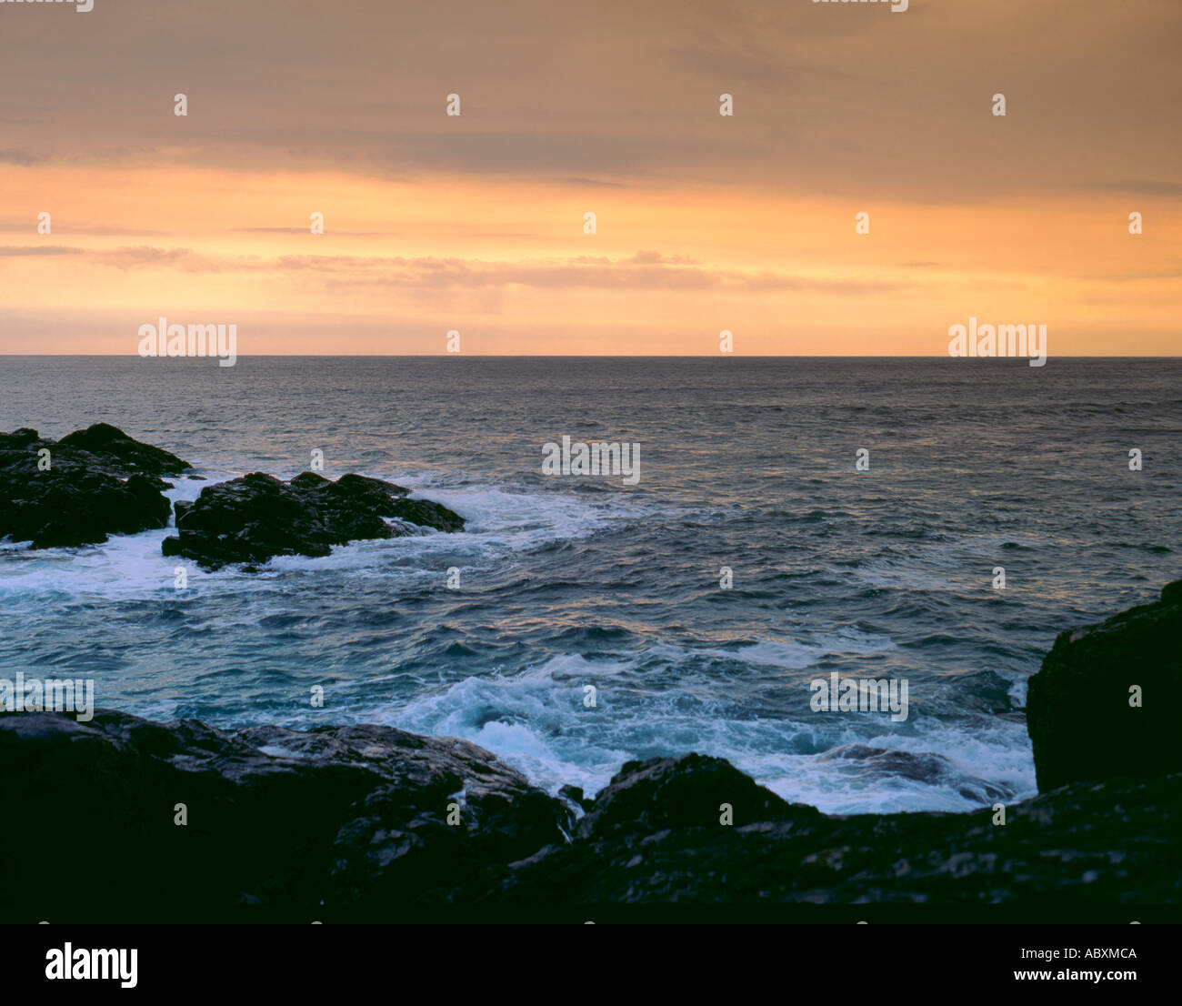 Sea breaking on a rocky shore at sunset; Halaman Bay, Barra, Outer Hebrides, Scotland, UK. Stock Photo