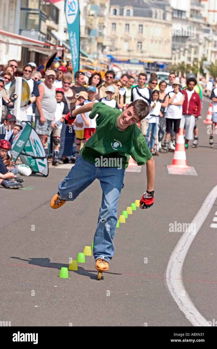 Young man roller blading through slalom cones  Stock Photo