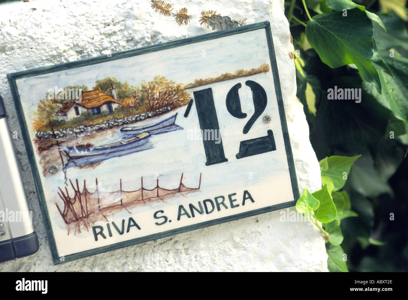 A decorative address plaque on a house in Grado, Italy. Stock Photo