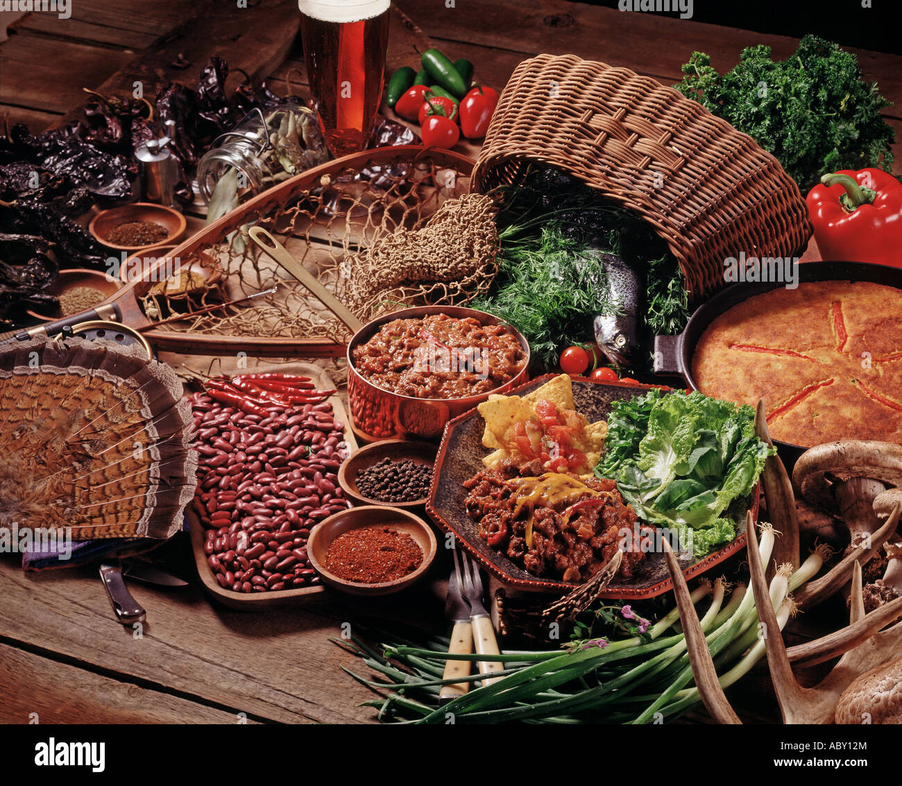 still life set up wild game for cookbook recipes fish fowl meat vegetables creel net Americana sportsman Stock Photo