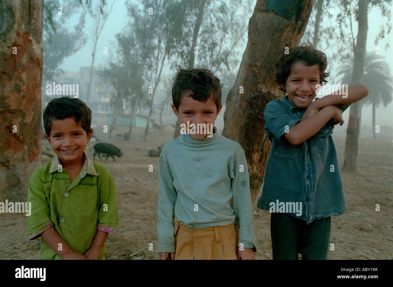 Three poor but cheerful Indian boys Stock Photo