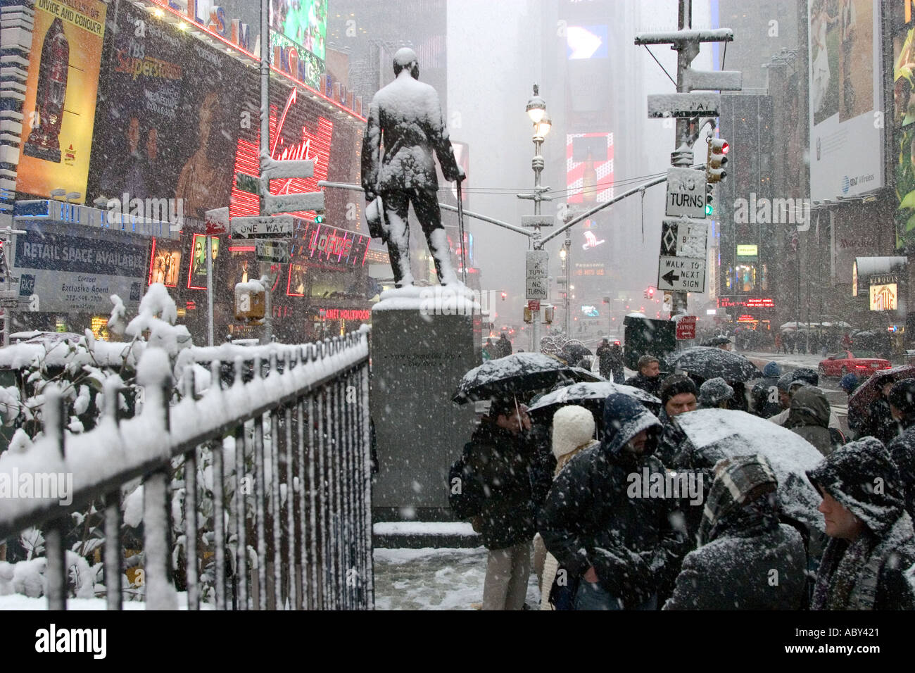 Theatre goers seeking discount tickets TCKTS wait in a snowstorm at 47th Street in Times Square Stock Photo