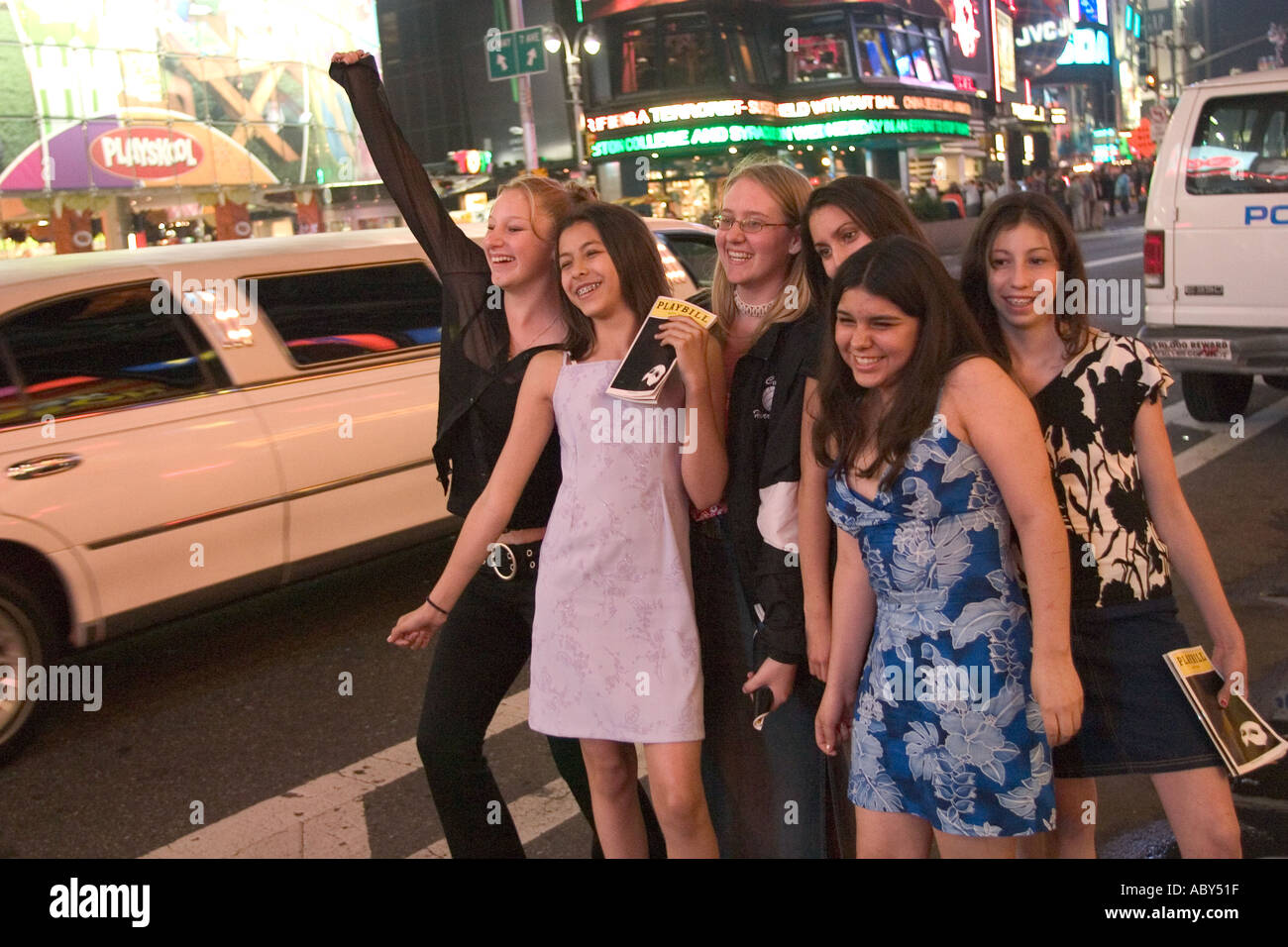 Young theatre goers in Times Square after attending a Broadway show  Stock Photo