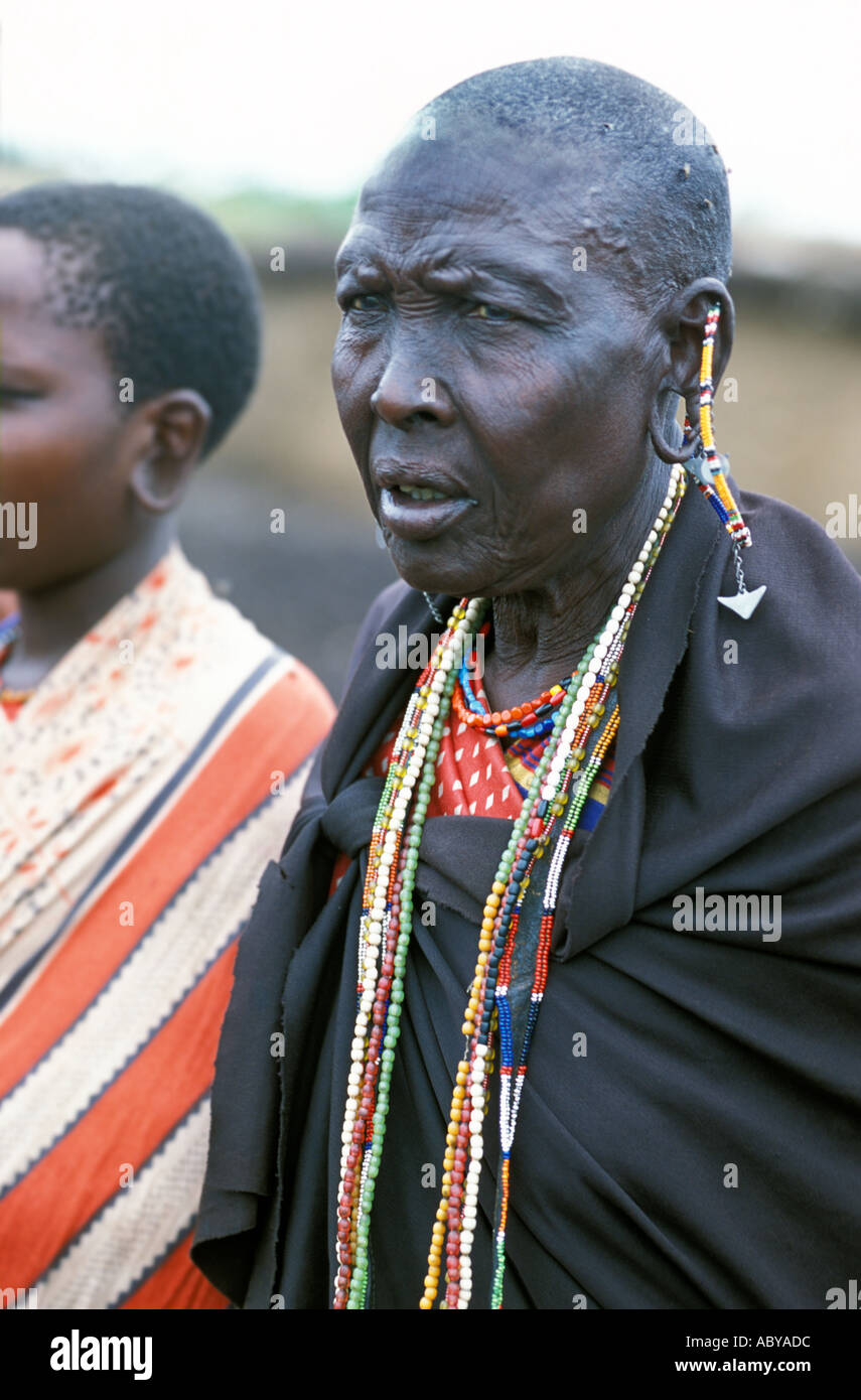 KENYA Masai Mara National Reserve Portrait of Masai woman in traditional dress and jewelry showing large hole pierced in her ear Stock Photo