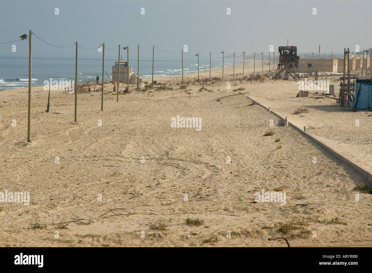 Isarel Gaza strip Gush Katif settlements Kfar Yam view of the beach with row of lamposts and military mirador Stock Photo