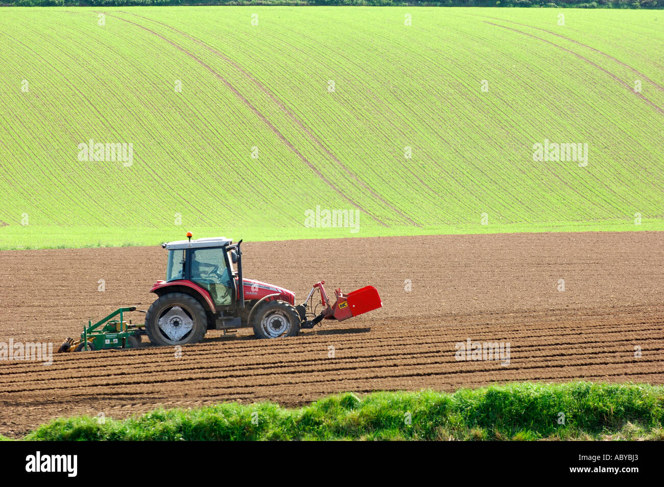 tractor working the ground County Down Northern Ireland Stock Photo Alamy