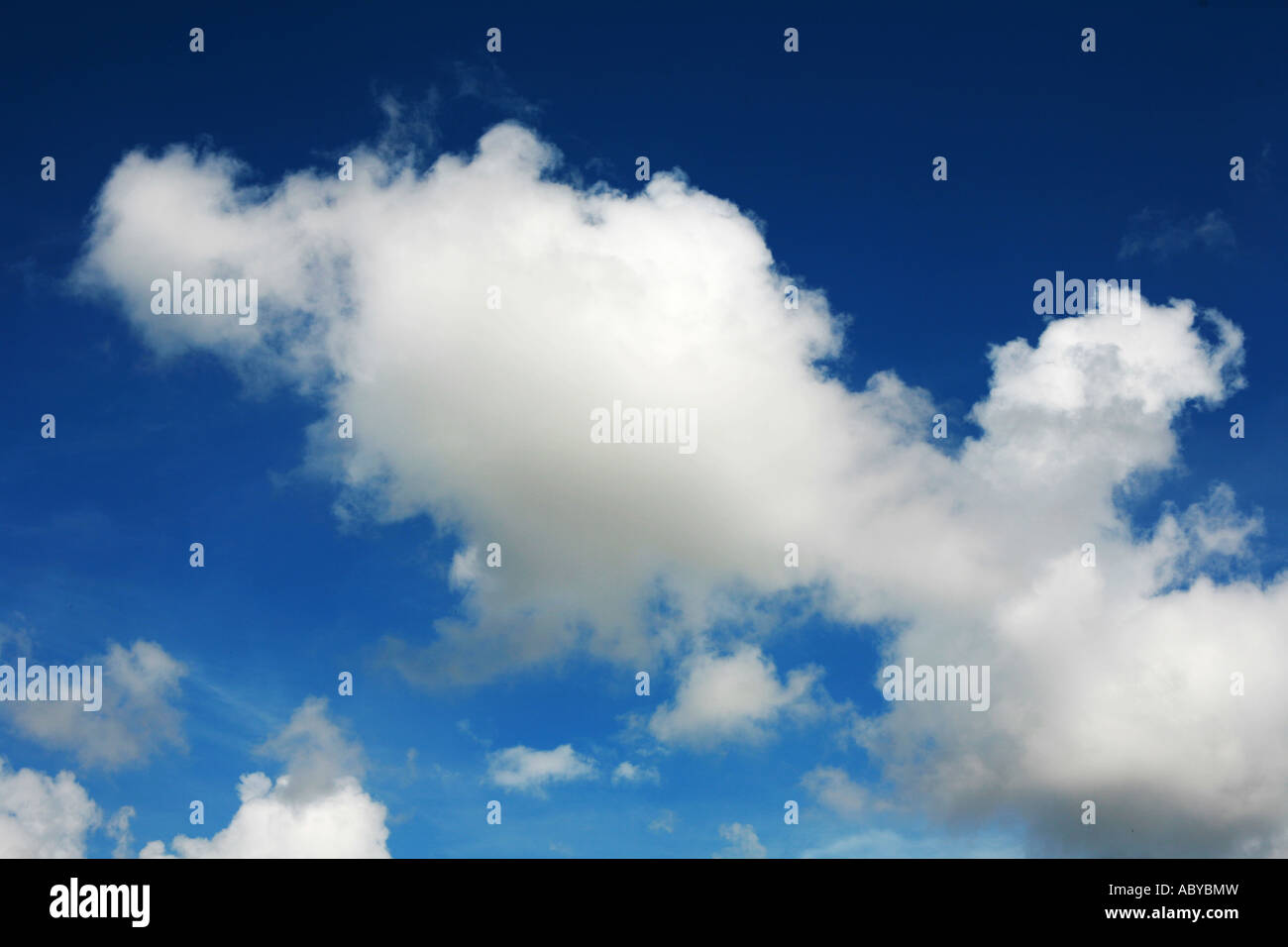 White fluffy clouds against a deep blue sky background Stock Photo - Alamy