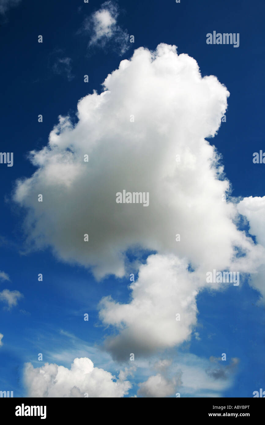 dramatic white fluffy clouds against a deep blue sky background UK ...
