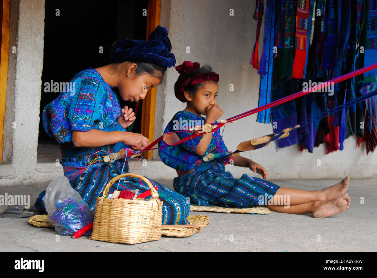 Mayan indigenous children weaving traditional textile, San Antonio Palopo, Lake Atitlan, Guatemala, Central America Stock Photo