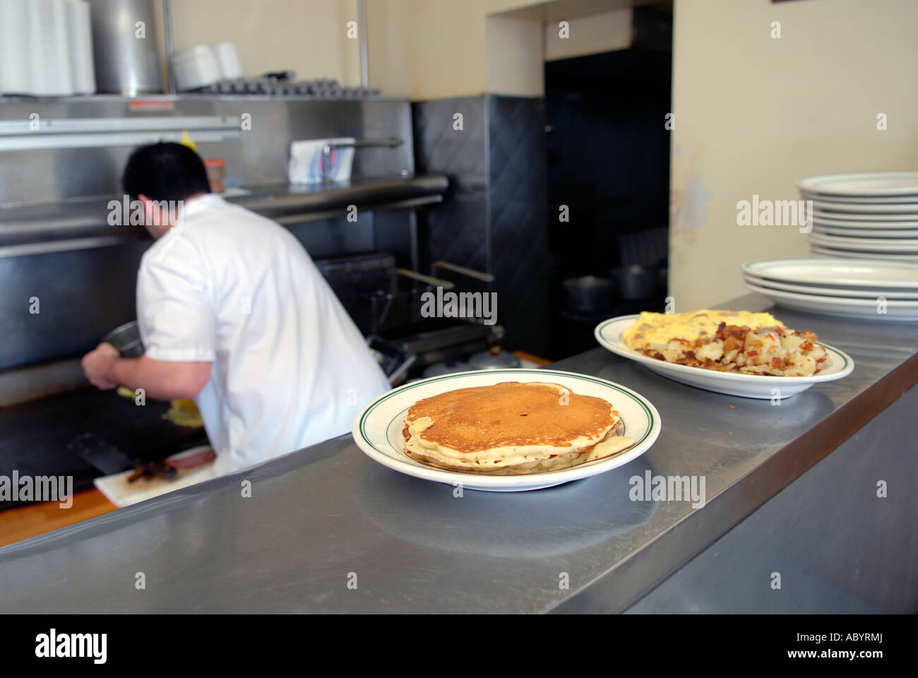 Short order cook prepares food in a small restaurant Stock Photo Alamy