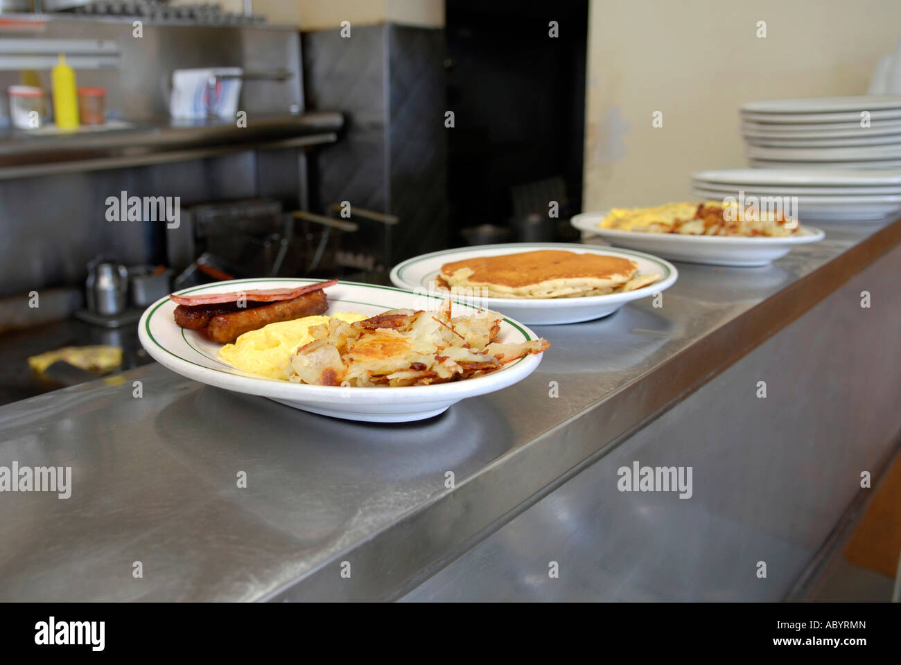 Short order cook prepares food in a small restaurant Stock Photo