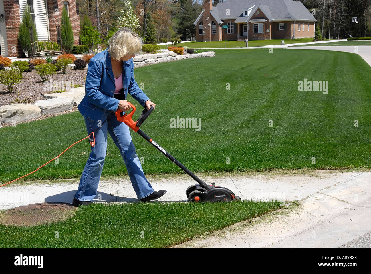 Adult female uses power electrical edging tool to enhance the
