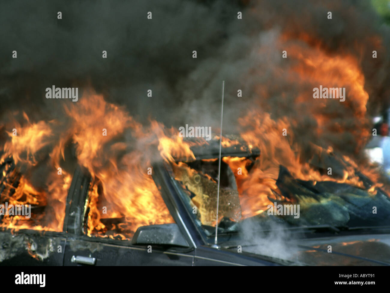 Flames and smoke coming from a car on Fire Stock Photo