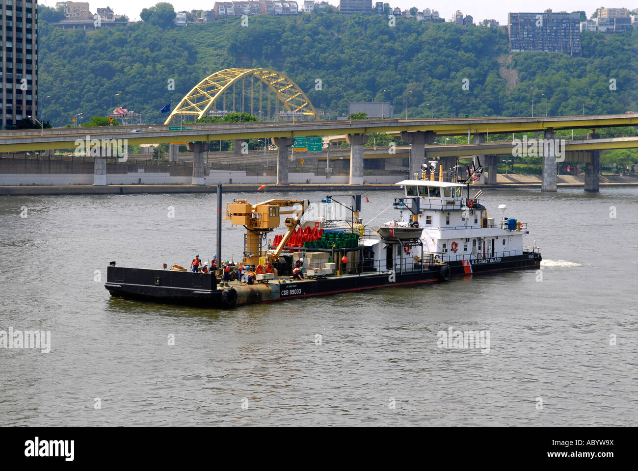 Construction barge with tugboat on the Monongahela River in the city of Pittsburgh Pennsylvania Pa USA Stock Photo