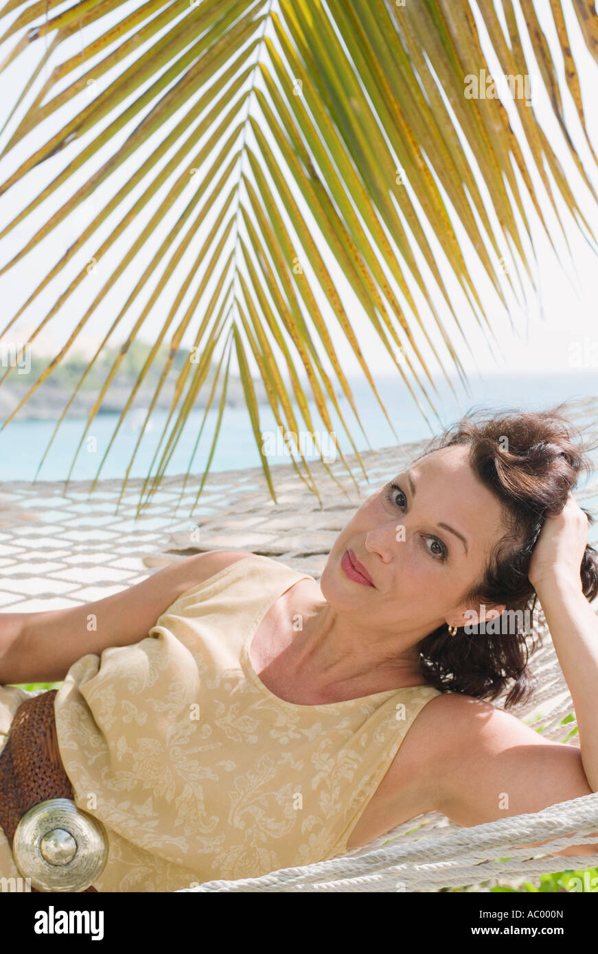 Woman relaxing in hammock Stock Photo - Alamy